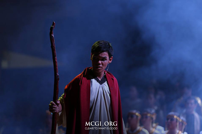 "Moses" as presented by the National Capital Region stands before the crowd during the penultimate number of their musical play.
