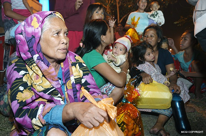 Two families receive gifts from MCGI on December 31st 2012.