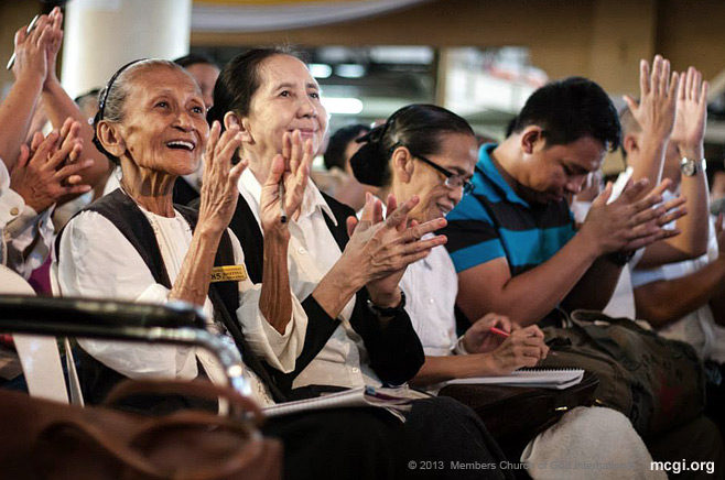 During a Thanksgiving of he Body in 2013, brethren clap and cheer during a biblical topic served by MCGI Leaders Bro. Eli Soriano and Bro. Daniel Razon. 