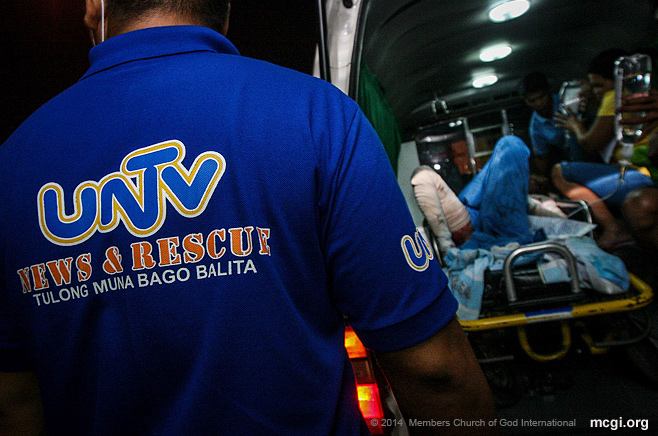 UNTV News and Rescue Team staff come to the aid of an injured man in Manila on January 1, 2014, as part of its Rescue First, Report Later advocacy that started in 2010.