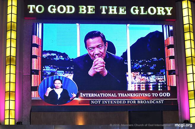 An interpreter for the deaf and mute does sign language as Bro. Eli Soriano speaks to MCGI brethren around the world via satellite and the internet. (Photo courtesy of Photoville International)